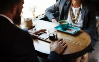 two people meeting over coffee