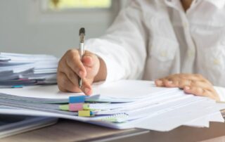 Volunteer working on organizing stacks of church documents
