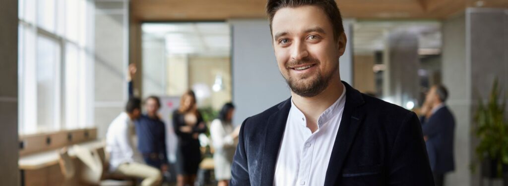 confident business owner with team in background